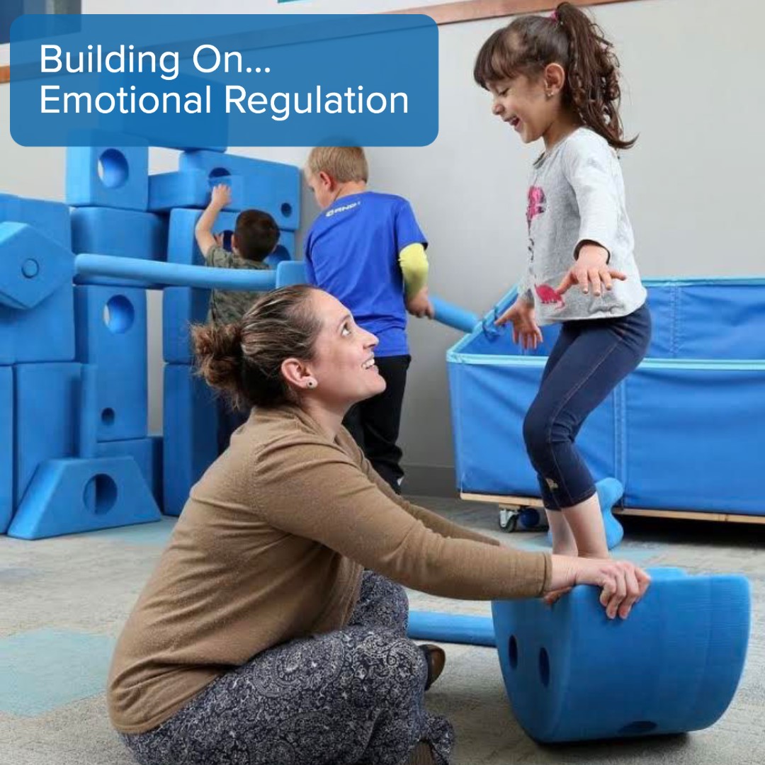 children and adult playing with big blue blocks