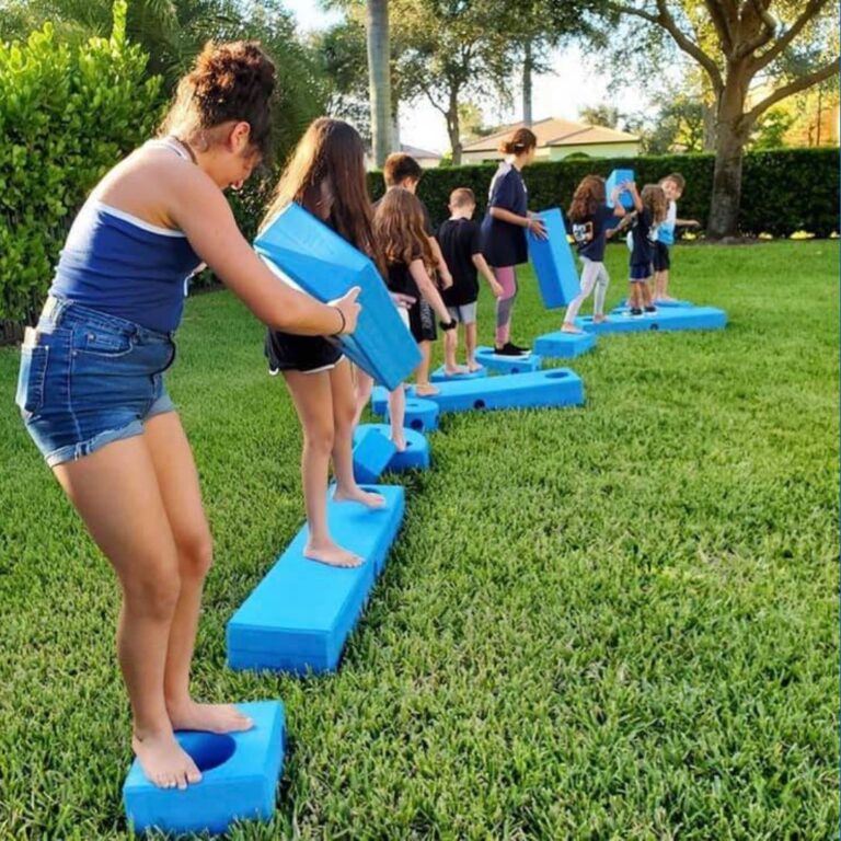 children playing with big blue blocks