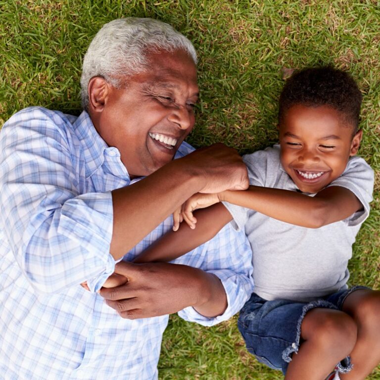 elderly man and young child laughing