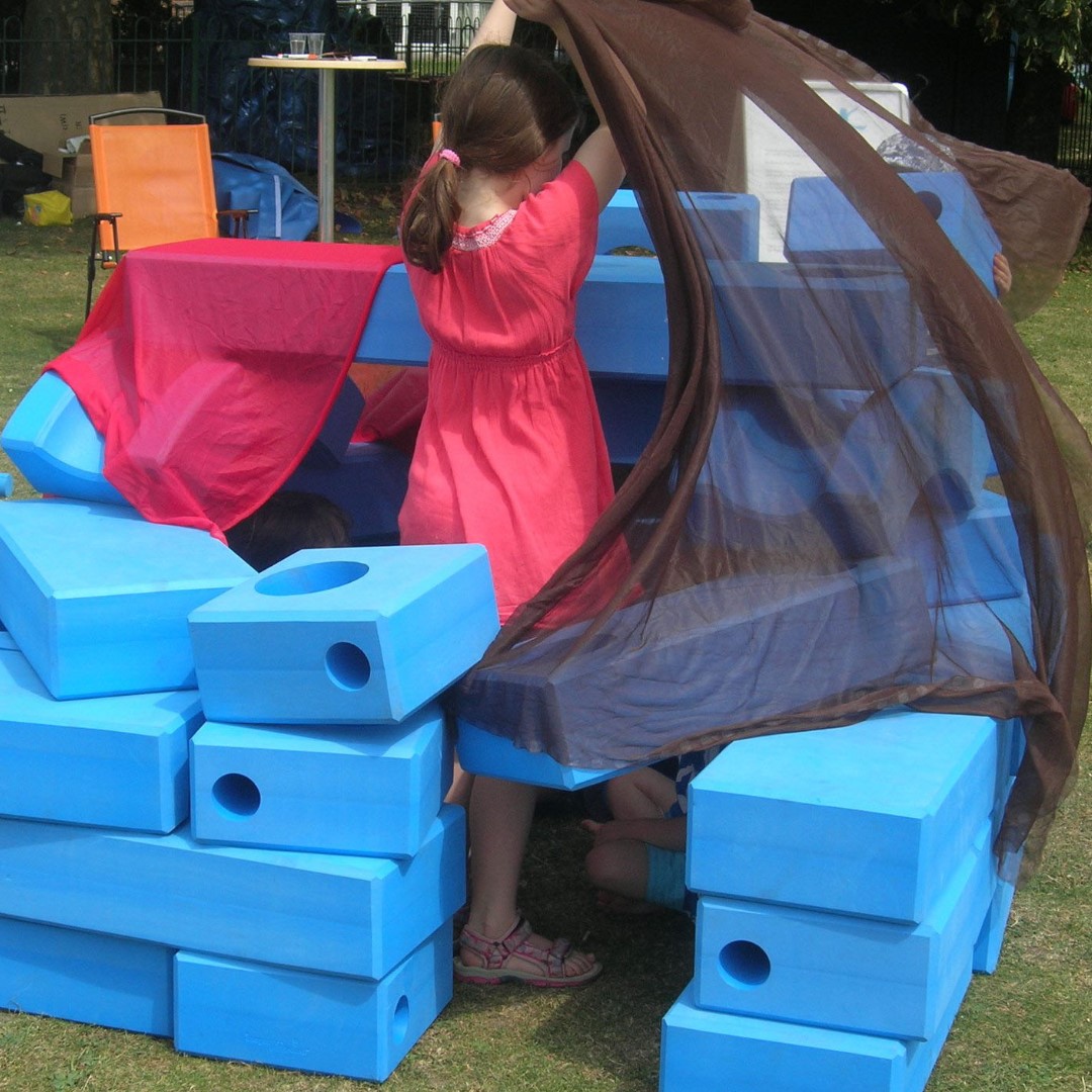 child playing with big blue blocks