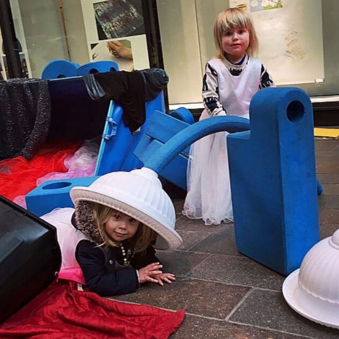 children playing with big blue blocks