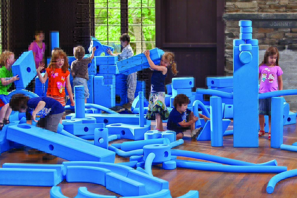 a group of kids playing with Imagination Playground Big blue blocks