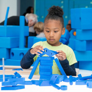 girl playing with Imagination Playground Small Blue Blocks