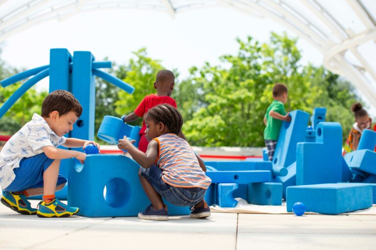 children playing with Imagination Playground Big Blue Blocks outdoors